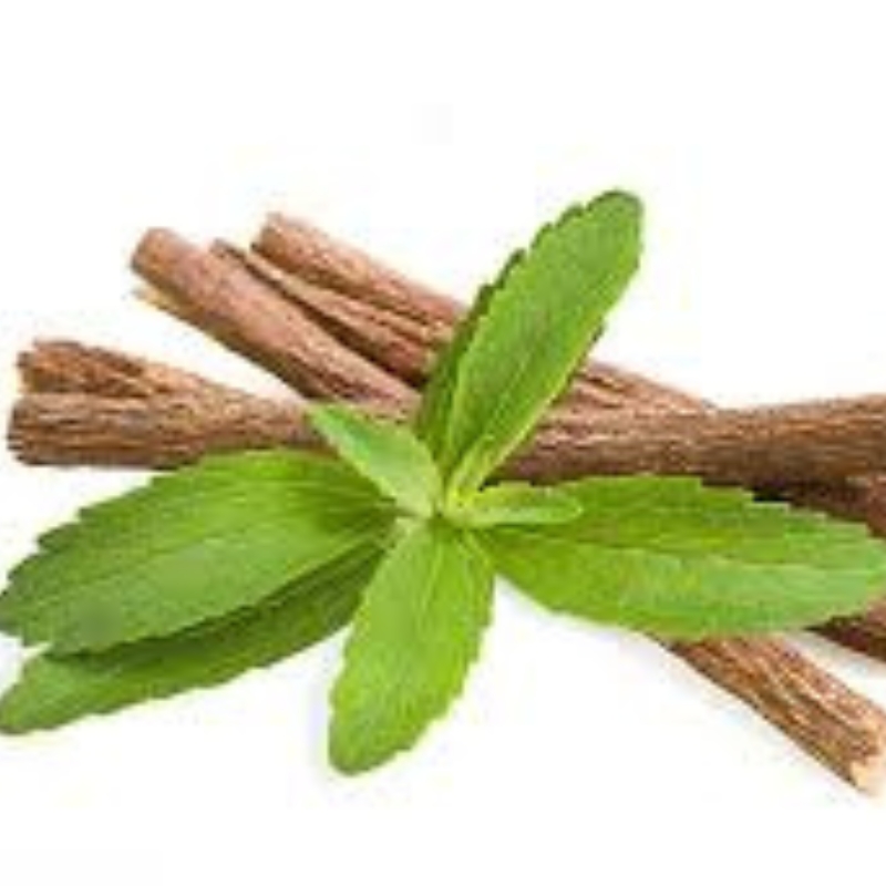Licorice (Mulethi) roots with fresh green leaves on a white background.